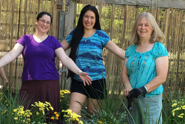 Garden advisors happily presenting freshly planted planters for random acts of gardening