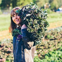 Andrea Bemis harvesting greens at her farm