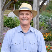 Charlie Nardozzi in a garden smiling