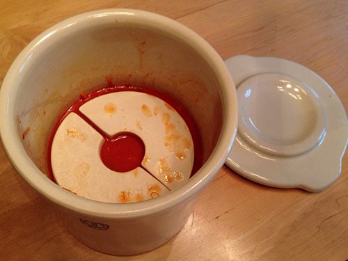 weights on top of kimchi in a fermentation crock 